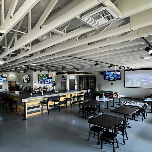 Interior of IWingz restaurant with a bar, tables, chairs, TVs, and a pool table.